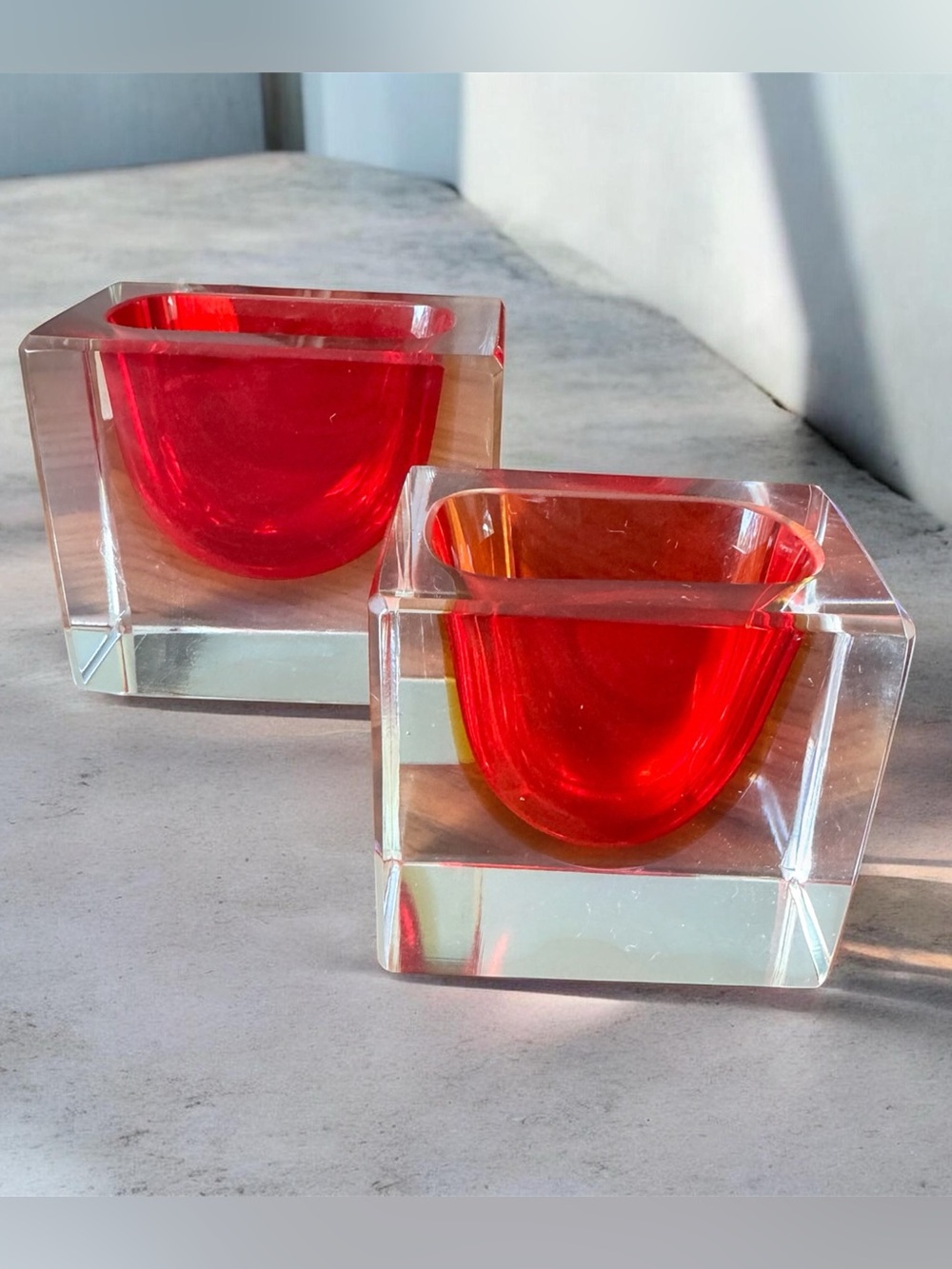 Bold red glasses cube holders with a curved red inner chamber